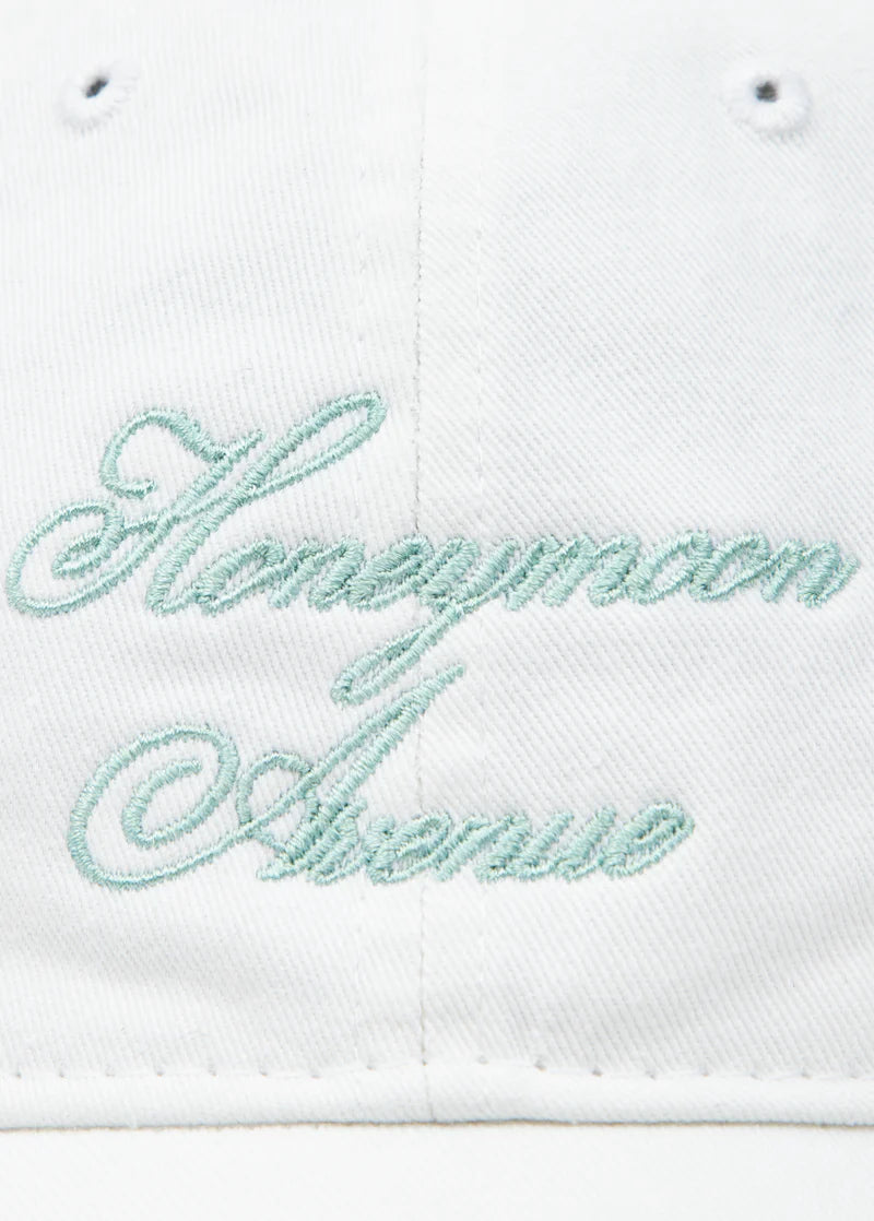 Close-up detail of Ariana Grande Honeymoon Avenue white dad hat featuring pastel embroidered script typography