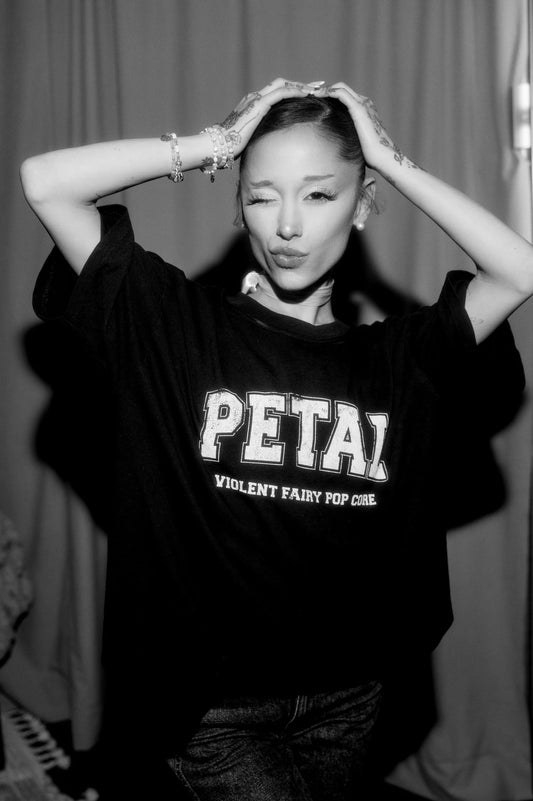 Model wearing Ariana Grande Petal Core Black T-Shirt showing the Petal Violent Fairy Pop Core front graphic