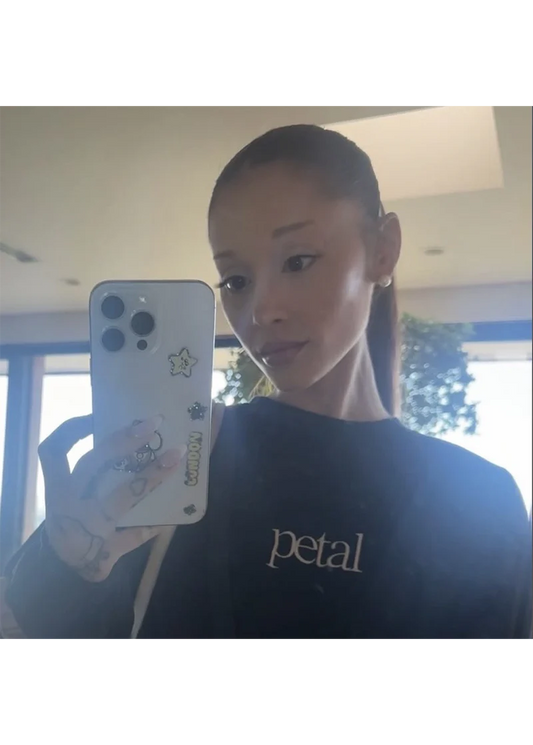 Ariana Grande wearing Petal black crewneck sweatshirt with minimalist embroidered logo in mirror selfie lifestyle shot