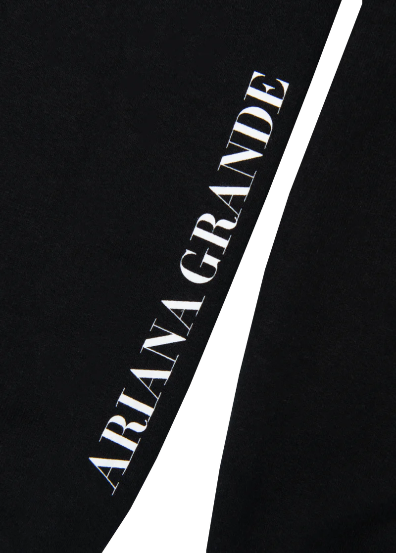 Black Ariana Grande crewneck sleeve detail with vertical white Ariana Grande logo print on cuff sleeve